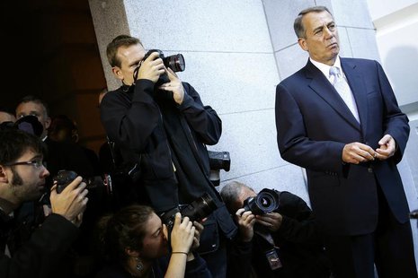 Photographers take pictures of U.S. House Speaker John Boehner (R-OH) (R) as he appears before reporters after a Republican caucus meeting a Photographers take pictures of U.S. House Speaker John Boehner (R-OH) (R) as he appears before reporters after a Republican caucus meeting a