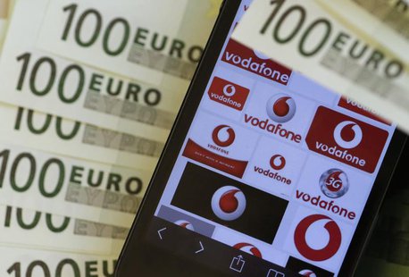 A photo illustration shows the company logo of mobile phone provider Vodafone and some 100 Euro bank notes in Vienna January 16, 2014. REUTE A photo illustration shows the company logo of mobile phone provider Vodafone and some 100 Euro bank notes in Vienna January 16, 2014. REUTE