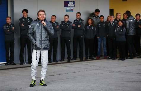 Mercedes Formula One racing driver Nico Rosberg of Germany stands before unveiling the new Mercedes F1 W05 car during its official presentat Mercedes Formula One racing driver Nico Rosberg of Germany stands before unveiling the new Mercedes F1 W05 car during its official presentat
