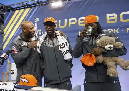 Denver Broncos free safety Mike Adams (L) interviews teammates Dominique Rodgers-Cromartie (C) and Danny Trevathan during Media Day for Supe Denver Broncos free safety Mike Adams (L) interviews teammates Dominique Rodgers-Cromartie (C) and Danny Trevathan during Media Day for Supe