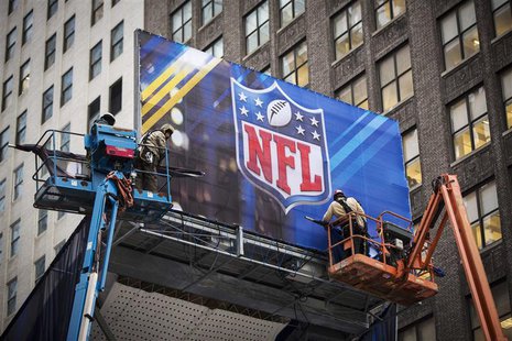 Workers hang signage on a booth on Broadway as preparations continue for Super Bowl XLVIII in New York January 28, 2014. REUTERS/Lucas Jacks Workers hang signage on a booth on Broadway as preparations continue for Super Bowl XLVIII in New York January 28, 2014. REUTERS/Lucas Jacks
