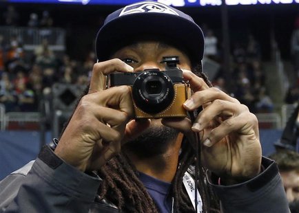 Seattle Seahawks cornerback Richard Sherman takes some pictures as he arrives for Media Day for Super Bowl XLVIII at the Prudential Center i Seattle Seahawks cornerback Richard Sherman takes some pictures as he arrives for Media Day for Super Bowl XLVIII at the Prudential Center i