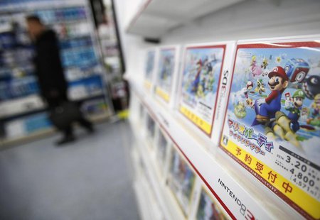 A man looks at items and accessories for Nintendo Co's Wii U game consoles, as its 3DS portable game console software are displayed at an el A man looks at items and accessories for Nintendo Co's Wii U game consoles, as its 3DS portable game console software are displayed at an el
