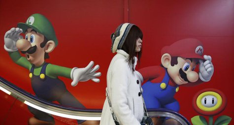 A shopper rides an escalator past Nintendo advertisements at an electronics retail store in Tokyo January 20, 2014. REUTERS/Yuya Shino A shopper rides an escalator past Nintendo advertisements at an electronics retail store in Tokyo January 20, 2014. REUTERS/Yuya Shino