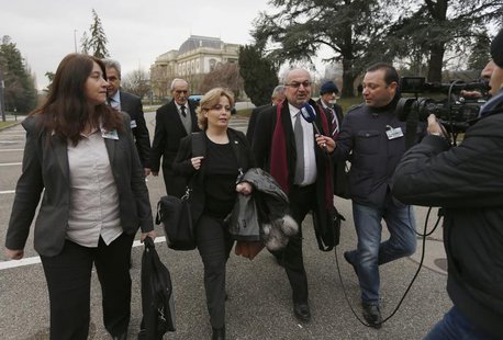 Members of Syrian opposition delegation Rima Fleihan (L), and Suheir Attasi (2nd L) and Abdulahad Astepho (3rd L) speak to a journalist as t Members of Syrian opposition delegation Rima Fleihan (L), and Suheir Attasi (2nd L) and Abdulahad Astepho (3rd L) speak to a journalist as t