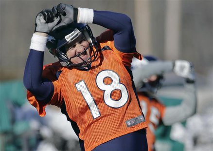 Denver Broncos quarterback Peyton Manning (18) does a stretching exercise during their practice session for the Super Bowl at the New York J Denver Broncos quarterback Peyton Manning (18) does a stretching exercise during their practice session for the Super Bowl at the New York J