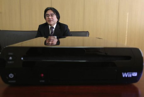 Nintendo Co's President Satoru Iwata speaks next to the company's Wii U game console during an interview with Reuters at the company headqua Nintendo Co's President Satoru Iwata speaks next to the company's Wii U game console during an interview with Reuters at the company headqua