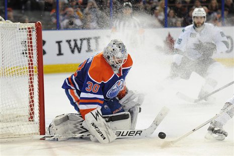 Jan 29, 2014; Edmonton, Alberta, CAN; Edmonton Oilers goalie Ben Scrivens (30) stops a shot during the third period against the San Jose Sha Jan 29, 2014; Edmonton, Alberta, CAN; Edmonton Oilers goalie Ben Scrivens (30) stops a shot during the third period against the San Jose Sha