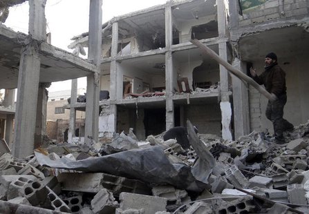 A man searches for belongings amid rubble of his damaged house in the Damascus suburbs of Arbeen, January 6, 2014. Picture taken January 6, A man searches for belongings amid rubble of his damaged house in the Damascus suburbs of Arbeen, January 6, 2014. Picture taken January 6,