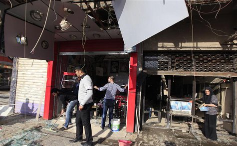 People gather at the site of a car bomb attack in Baghdad, January 30, 2014. REUTERS/Ahmed Saad People gather at the site of a car bomb attack in Baghdad, January 30, 2014. REUTERS/Ahmed Saad