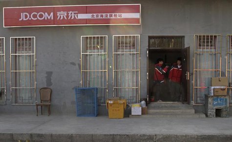 Two Jingdong, also known as JD.com, couriers chat at the entrance to the company's Haidian district delivery station in Beijing, November 20 Two Jingdong, also known as JD.com, couriers chat at the entrance to the company's Haidian district delivery station in Beijing, November 20