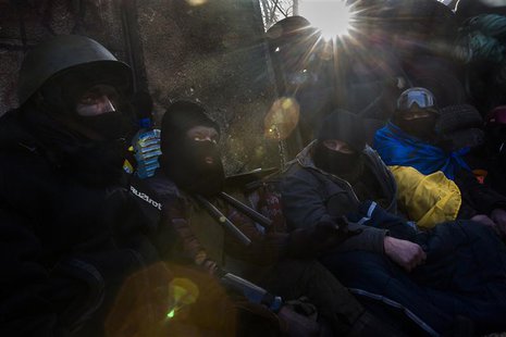 Anti-government protesters huddle under blankets as temperatures stand at minus 20 degrees Celsius (minus 4 degrees Fahrenheit) at a barrica Anti-government protesters huddle under blankets as temperatures stand at minus 20 degrees Celsius (minus 4 degrees Fahrenheit) at a barrica