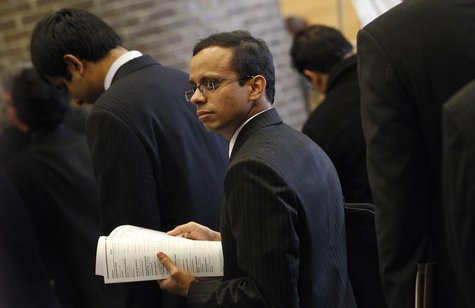 A job seeker waits in line with others to meet potential employers at a career fair at Rutgers University in New Brunswick, New Jersey, Janu A job seeker waits in line with others to meet potential employers at a career fair at Rutgers University in New Brunswick, New Jersey, Janu