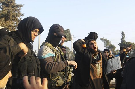 Fighters from the Islamic State in Iraq and the Levant (ISIL) try to calm civilians demonstrating against the rebel infighting in Aleppo Jan Fighters from the Islamic State in Iraq and the Levant (ISIL) try to calm civilians demonstrating against the rebel infighting in Aleppo Jan