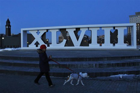 A woman walks with her dog next to roman numerals for NFL Super Bowl XLVIII football game in Hoboken, New Jersey, January 30, 2014. REUTERS/ A woman walks with her dog next to roman numerals for NFL Super Bowl XLVIII football game in Hoboken, New Jersey, January 30, 2014. REUTERS/