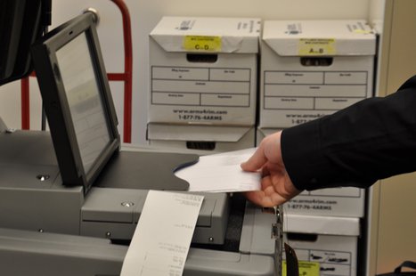 Brown County Deputy Clerk Justin Schmit feeds a ballot into the new voting machine. (Photo from FOX 11). Brown County Deputy Clerk Justin Schmit feeds a ballot into the new voting machine. (Photo from FOX 11).