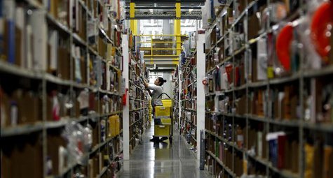 A worker gathers items for delivery from the warehouse floor at Amazon's distribution center in Phoenix, Arizona November 22, 2013. REUTERS/ A worker gathers items for delivery from the warehouse floor at Amazon's distribution center in Phoenix, Arizona November 22, 2013. REUTERS/