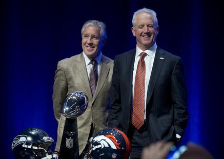 Head coach Pete Carroll (L) of the Seattle Seahawks and head coach John Fox of the Denver Broncos pose for a photo before their news confere Head coach Pete Carroll (L) of the Seattle Seahawks and head coach John Fox of the Denver Broncos pose for a photo before their news confere