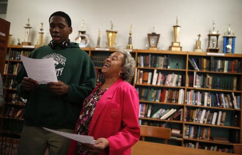 Velma Smith sings with one of the students in the library at Leo Catholic High School in Chicago, Illinois February 14, 2013. REUTERS/Jim Yo Velma Smith sings with one of the students in the library at Leo Catholic High School in Chicago, Illinois February 14, 2013. REUTERS/Jim Yo