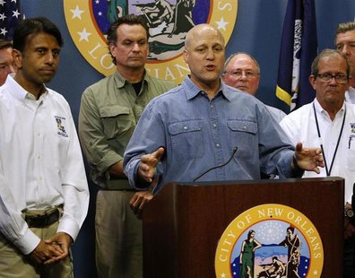 New Orleans Mayor Mitch Landrieu talks about Tropical Storm Isaac as Louisiana Governor Bobby Jindal (L) looks on during a news conference a New Orleans Mayor Mitch Landrieu talks about Tropical Storm Isaac as Louisiana Governor Bobby Jindal (L) looks on during a news conference a