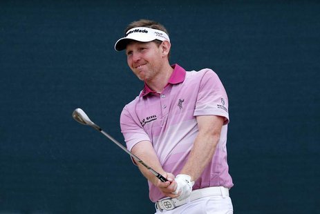 Stephen Gallacher of Scotland watches his shot on the 18th hole during the third round of the 2014 Omega Dubai Desert Classic in Dubai Febru Stephen Gallacher of Scotland watches his shot on the 18th hole during the third round of the 2014 Omega Dubai Desert Classic in Dubai Febru