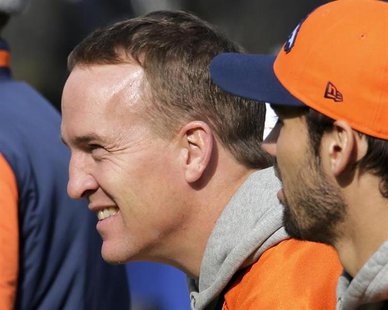 Denver Broncos quarterback Peyton Manning (L) looks over the field as he sits on the bench with tight end Joel Dreessen (81) during their "w Denver Broncos quarterback Peyton Manning (L) looks over the field as he sits on the bench with tight end Joel Dreessen (81) during their "w