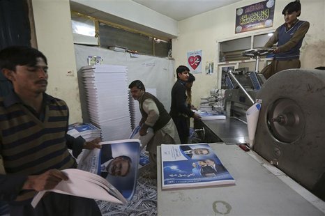 Labourers print posters of presidential election candidates at a printing press in Kabul, January 29, 2014. REUTERS/Omar Sobhani Labourers print posters of presidential election candidates at a printing press in Kabul, January 29, 2014. REUTERS/Omar Sobhani