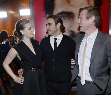 Cast members Amy Adams and Joaquin Phoenix stand next to writer/director Spike Jonze at the film premiere of "Her" at the Directors Guild of Cast members Amy Adams and Joaquin Phoenix stand next to writer/director Spike Jonze at the film premiere of "Her" at the Directors Guild of