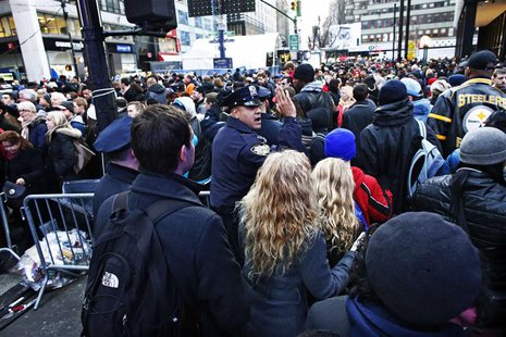A New York Police officer tries to control the massive traffic of fans while they gather en masse at Super Bowl Boulevard zone ahead of Supe A New York Police officer tries to control the massive traffic of fans while they gather en masse at Super Bowl Boulevard zone ahead of Supe