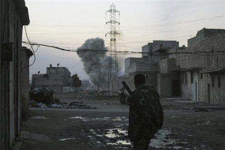 Smoke rises while a Free Syrian Army fighter stands at the Karm al-Tarab neighborhood frontline in Aleppo February 1, 2014. REUTERS/Ammar Ab Smoke rises while a Free Syrian Army fighter stands at the Karm al-Tarab neighborhood frontline in Aleppo February 1, 2014. REUTERS/Ammar Ab