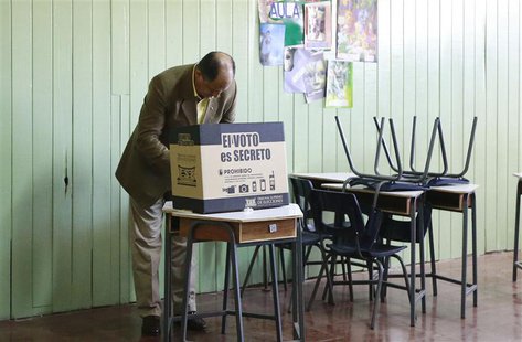Luis Guillermo Solis, presidential candidate for Citizens' Action Party, casts his vote at a polling station during the presidential electio Luis Guillermo Solis, presidential candidate for Citizens' Action Party, casts his vote at a polling station during the presidential electio