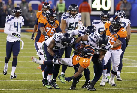 Denver Broncos Knowshon Moreno (C) is tackled by Seattle Seahawks Chris Clemons (91) in the first quarter during the NFL Super Bowl XLVIII f Denver Broncos Knowshon Moreno (C) is tackled by Seattle Seahawks Chris Clemons (91) in the first quarter during the NFL Super Bowl XLVIII f