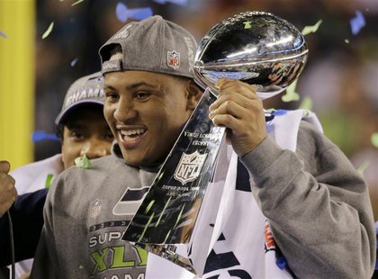 Seattle Seahawks outside linebacker Malcolm Smith celebrates with the Vince Lombardi trophy after defeating the Denver Broncos in the NFL Su Seattle Seahawks outside linebacker Malcolm Smith celebrates with the Vince Lombardi trophy after defeating the Denver Broncos in the NFL Su