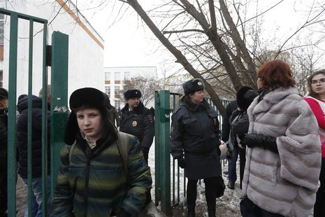 Interior Ministry members evacuate people after an armed student took hostages at a high school on the outskirts of Moscow, February 3, 2014 Interior Ministry members evacuate people after an armed student took hostages at a high school on the outskirts of Moscow, February 3, 2014