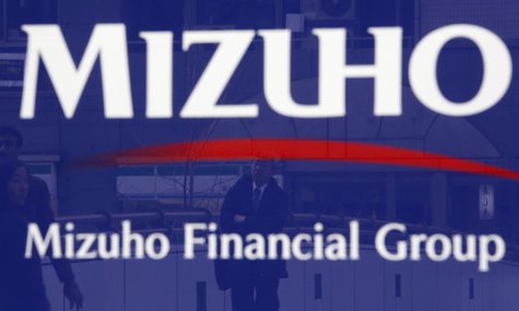 A man is reflected on an advertisement board of Mizuho Financial Group's Mizuho Bank in Tokyo January 30, 2014. REUTERS/Yuya Shino A man is reflected on an advertisement board of Mizuho Financial Group's Mizuho Bank in Tokyo January 30, 2014. REUTERS/Yuya Shino