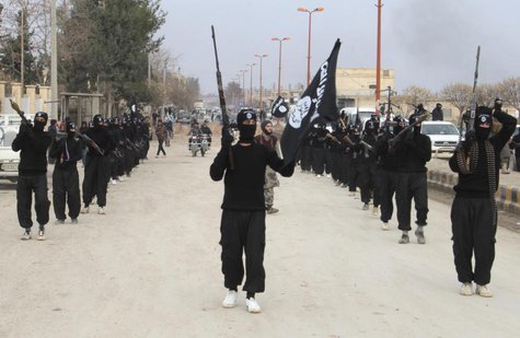 Fighters of al-Qaeda linked Islamic State of Iraq and the Levant carry their weapons during a parade at the Syrian town of Tel Abyad, near t Fighters of al-Qaeda linked Islamic State of Iraq and the Levant carry their weapons during a parade at the Syrian town of Tel Abyad, near t