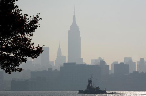 The haze shrouded skyline of New York is a backdrop for a boat moving up the Hudson River in Hoboken, New Jersey August 3, 2006. REUTERS/Gar The haze shrouded skyline of New York is a backdrop for a boat moving up the Hudson River in Hoboken, New Jersey August 3, 2006. REUTERS/Gar