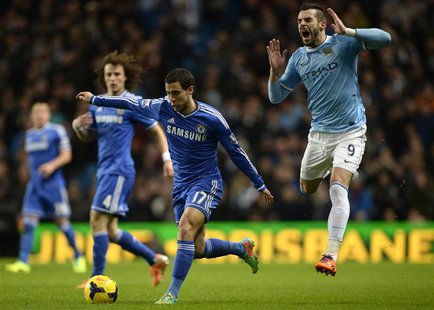 Manchester City's Alvaro Negredo (R) is challenged by Chelsea's Eden Hazard during their English Premier League soccer match at the Etihad S Manchester City's Alvaro Negredo (R) is challenged by Chelsea's Eden Hazard during their English Premier League soccer match at the Etihad S