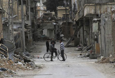 Men chat near buildings damaged by what activists said was shelling by forces loyal to Syria's President Bashar al-Assad in Daraya, near Dam Men chat near buildings damaged by what activists said was shelling by forces loyal to Syria's President Bashar al-Assad in Daraya, near Dam