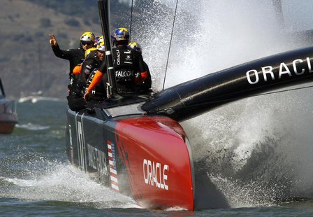Oracle Team USA skipper Jimmy Spithill (L) waves to the crowd after defeating Emirates Team New Zealand during Race 16 of the 34th America's Oracle Team USA skipper Jimmy Spithill (L) waves to the crowd after defeating Emirates Team New Zealand during Race 16 of the 34th America's