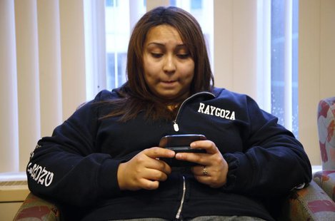 Jazmine Raygoza sends a text message to her brother and sister as she waits at Rose Medical Center in Denver June 20, 2011 just before her L Jazmine Raygoza sends a text message to her brother and sister as she waits at Rose Medical Center in Denver June 20, 2011 just before her L