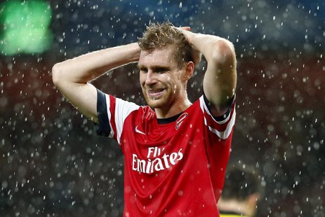 Arsenal's Per Mertesacker reacts after being defeated by Borussia Dortmund in their Champions League soccer match at the Emirates stadium in Arsenal's Per Mertesacker reacts after being defeated by Borussia Dortmund in their Champions League soccer match at the Emirates stadium in