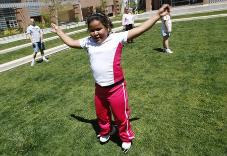 Fernanda Garcia-Villanueva, 8, does jumping jacks at a group exercise session in the 10-week Shapedown Program at The Children's Hospital in Fernanda Garcia-Villanueva, 8, does jumping jacks at a group exercise session in the 10-week Shapedown Program at The Children's Hospital in