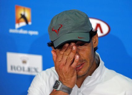Rafael Nadal of Spain wipes his face at a news conference after losing his men's singles final match against Stanislas Wawrinka of Switzerla Rafael Nadal of Spain wipes his face at a news conference after losing his men's singles final match against Stanislas Wawrinka of Switzerla
