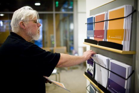 California state worker Curtis Walker looks over retirement plan brochures at the Calpers regional office in Sacramento, California October California state worker Curtis Walker looks over retirement plan brochures at the Calpers regional office in Sacramento, California October