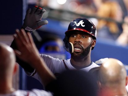 Atlanta Braves' Jason Heyward celebrates in the dugout after scoring on a single against the Milwaukee Brewers in the sixth inning at their Atlanta Braves' Jason Heyward celebrates in the dugout after scoring on a single against the Milwaukee Brewers in the sixth inning at their