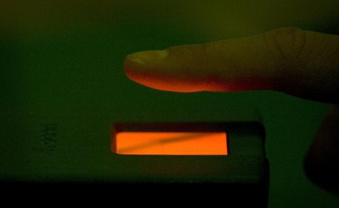 A man holds his finger over a scanning unit at the local registration office at the city hall in Potsdam November 1, 2007. REUTERS/Tobias Sc A man holds his finger over a scanning unit at the local registration office at the city hall in Potsdam November 1, 2007. REUTERS/Tobias Sc