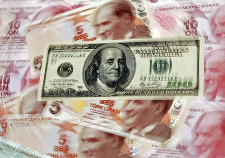 A U.S. 100 dollar banknote is seen on top of 5 and 10 lira banknotes in this illustration picture taken in Istanbul January 28, 2014. REUTER A U.S. 100 dollar banknote is seen on top of 5 and 10 lira banknotes in this illustration picture taken in Istanbul January 28, 2014. REUTER
