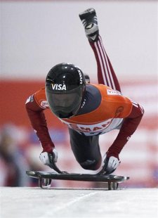 John Fairbairn of Canada jumps on his sled in the first run during the men's skeleton race at the FIBT Bobsleigh and Skeleton World Cup comp John Fairbairn of Canada jumps on his sled in the first run during the men's skeleton race at the FIBT Bobsleigh and Skeleton World Cup comp