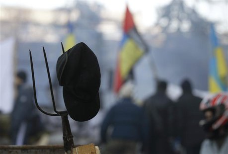 A pitchfork is seen behind anti-government protesters at the barricades in Kiev February 4, 2014. REUTERS/Vasily Fedosenko A pitchfork is seen behind anti-government protesters at the barricades in Kiev February 4, 2014. REUTERS/Vasily Fedosenko